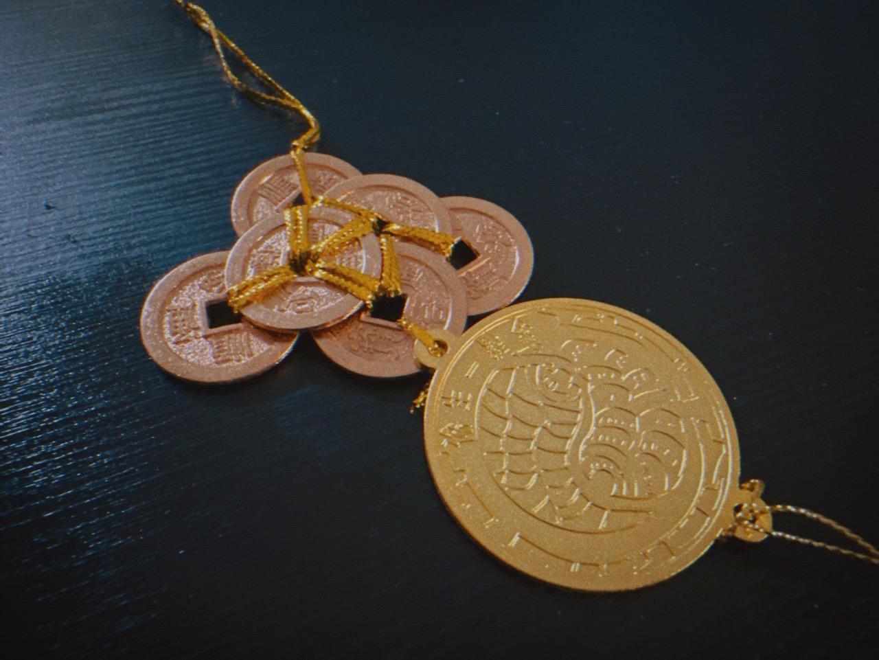 Full view of 2026 Feng Shui coin set showing 6 copper coins connected to gold Bagua prosperity medallion