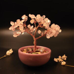 Rose quartz crystal bonsai tree in blush pink ceramic bowl filled with colorful crystal gravel